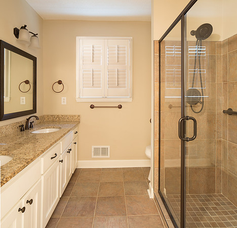 Updated bathroom with double vanity and walk-in shower
